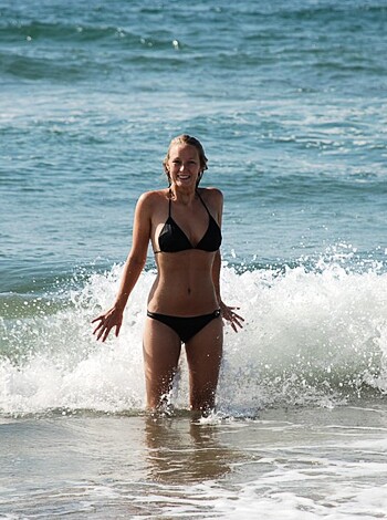 A naked broad in a see-through thong bikini pants, standing fucking ass-up in the goddamn fucking ocean, with her tits swaying like two massive goddamn watermelons.