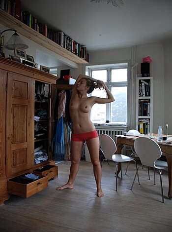 Vulgar description of image:
This asshole is standing in the fucking kitchen with his dick out, checking out the goddamn cups and plates in the open-ass cabinet.