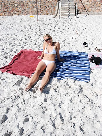 "Yo, check out this hot chick on the sandy shore, sportin' only a barely-there thong, tits swayin', sun rays playin'. Damn, that's some beach bitch action."