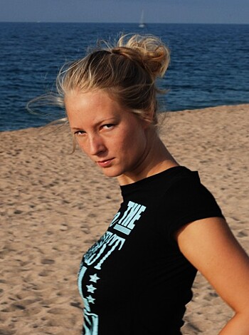 A shaven titted slutty bitch on the sandy shore.