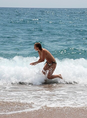 "You can see a hot chick in a skimpy bikini, strolling towards the sea. She looks like she wants to get f*cked up by those crashing waves."
