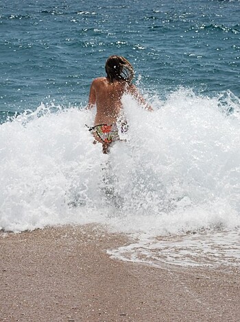 Fucking hot nude chick swims in goddamn sea with her fat tits bouncing up and down like frigging jelly rolls while she rides on that big wave like a motherfucker.