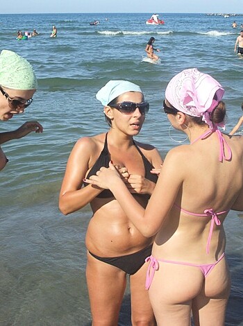 Here's a f*cking nude beach image of dudes and babes strolling around with their asses out, playing in the motherf*cking ocean waters like it ain't no thing.