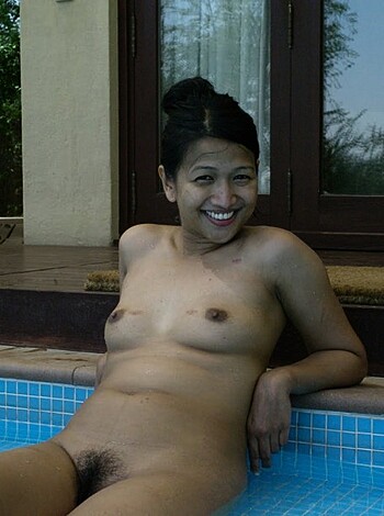 """
A busty blonde babe in a revealing bikini is chillin' at the pool with her melons exposed for all to see. 
"""