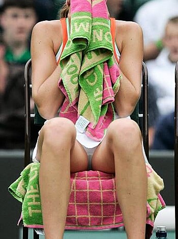 """
Hey bitches! Look at this hot piece of ass with the perfect body and flawless tits sitting there with a cute little visor covering that damn perfect blonde hair while she's got a pink towel trying to cover up her sweaty face after working out. And she's even holding another one in her hand just for effect, because that's how sexy she is!
"""