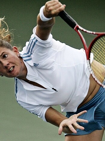 Here's the fuckin' caption for ya, asshole. Check out this hot-ass shot of some dumb bitch tryin' to play tennis with her stupid tits and ass all up in my face like I give a shit about that shit. Yeah, bro, she's fuckin' lunging forward with her goddamn racket like it matters or something. Fuckin' ridiculous, man. Fuckin' tennis. Buncha rich assholes playin' a game they don't even need to play, wasting my time with their stupid bullshit. Fuckin' tennis. Why the fuck would anyone want to watch this shit?