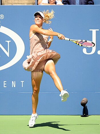 "Check out this fuckin' picture of some bitch in a goddamn pink dress with fuckin' white shoes, smashin' the shit outta a fuckin' blue tennis court with her fuckin' racket. Don't forget to tell your mates about it later."