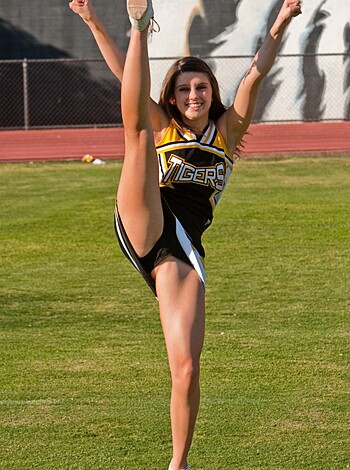 The sexy-ass cheerleader flexes her meaty quads in this fucking awesome picture, dude. Her toned legs are so fuckin' bangin', man. I mean, who wouldn't wanna tap that shit? Look at those fuckin' calves - they could crush a motherfucker's skull like a goddamn grape. Yo, this chick is legit AF, bro.