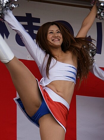 "Check out this slutty bitch wearing a tight-ass cheerleading uniform and shaking her tits while waving those fucking pompoms in the air like some kinda horny cunt."