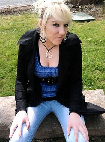 A young bitch with tits hanging out of her tight-assed top is chillin' on a fucking rockin' slab, lookin' like she wants some cock shit up her ass.