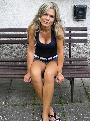Here's a picture of some bitch with huge titties and a fat ass, dressed in a tiny ass shirt and fucking shorts, sitting on a bench like a slutty cunt.