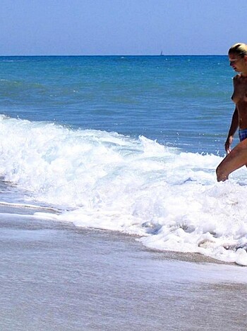 "Fucking hot chick with tits out on the sandy shore."