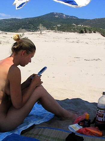 Vulgar, factual description of image:
A fuckin' hot chick is laying on a beach chair sans bikini top. She ain't wearing no panties either, and her tits are bouncin'. The scene looks like some sexy-ass sunbathing action, with nothin' but a cool breeze blowin' through the place.