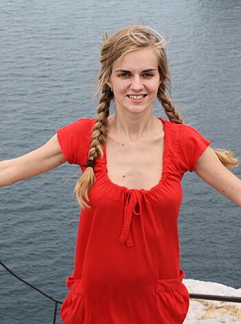 Here's a picture of some hot chick with tits out standing on a fuckin' rocky coast, ya dig?