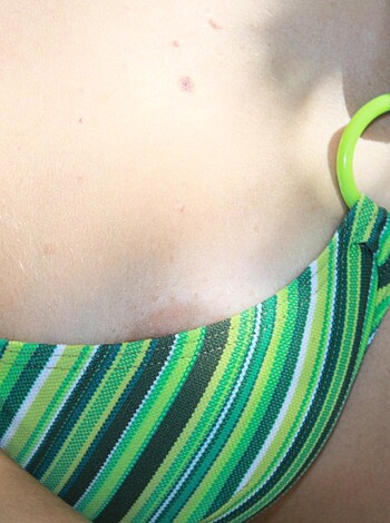 Fucking hot babe with green necklace showing off her tits in an untied top.