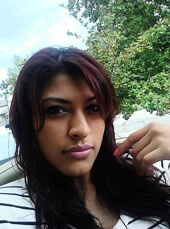 Here's a hot f*cking chick with red hair, dressed in a tight-ass black and white t-shirt.