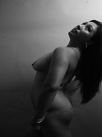 "
 A fat-assed bitch lying on her back with a pouty face staring at the camera, wearing nothing but high heels and a dainty necklace. She looks like shit.
"