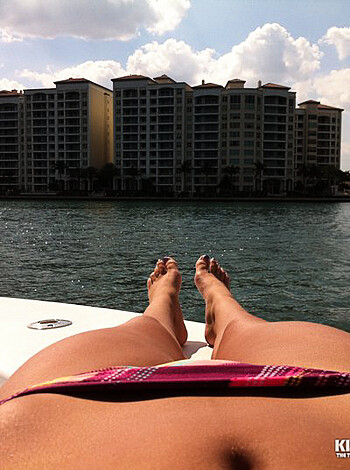 The fucking picture of a slutty bitch lying on a goddamn boat, showing off her ass and tits for the world to see.