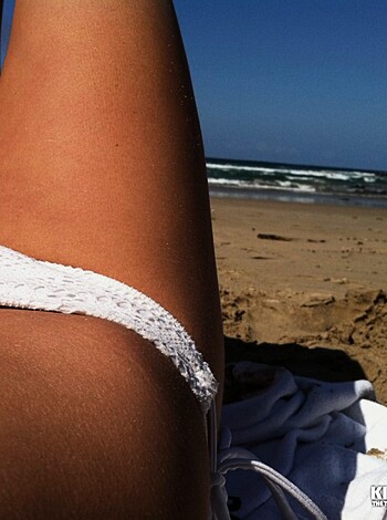 Vulgar description: "Fuckin' hot bitch on the beach with her ass cheeks peeking out of her panties."