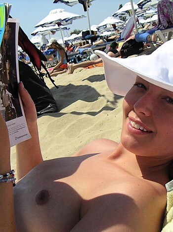 "This bitch is chillin' on the sandy shore with a cocktail in one hand and some smut mags for the other."