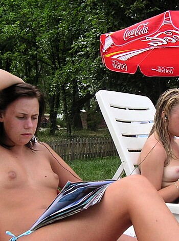 """
Two sluts basking in the sun with a pimped-out beach chair and not giving a shit about anything else but each other's tits and pussy.
""