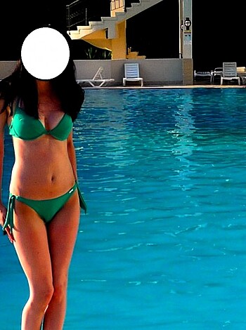 "Chick in string bikini, showing off her ass by the pool."