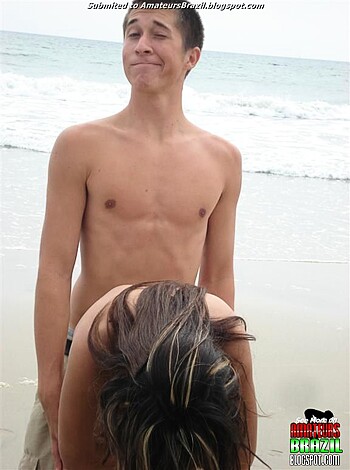 A douchebag is puking his guts out on the shore while his bros laugh their asses off in the background.