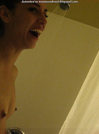 Image of naked, wet tits bouncing around while a chick is cackling like crazy in the shower.