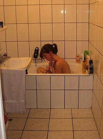 A nude bitch taking a bath.
