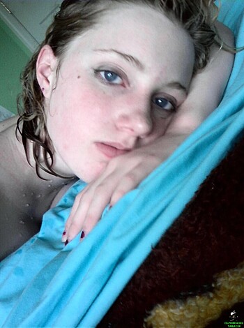 Fucking hot bitch laying on the bed with ass up, wearing some earrings and fingers fiddling in her hairy pussy.