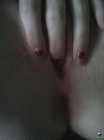 Vulva bared, panties pulled down low, hand on thighs.