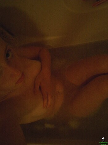 "Here's a nude bitch soaking her pussy in a tub of warm water."