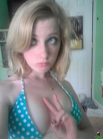 Here's a slutty bitch showing off her tits while making dumbass hand gestures, as if anyone gives a fuck about her retarded poses or the beach in the background. Fucking moron.