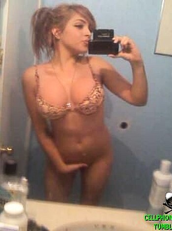 A naked babe in underwear, staring at the camera with her ass up.