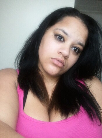A horny bitch in a skimpy pink bra is posing seductively, but her fuckin' hair is blocking the view of her sexy face.
