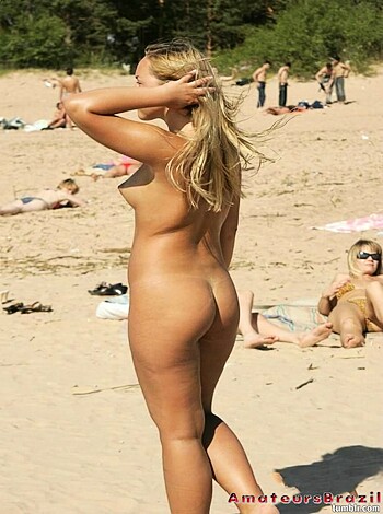 Here's a fat-assed bitch with her pussy hanging out on some sand.