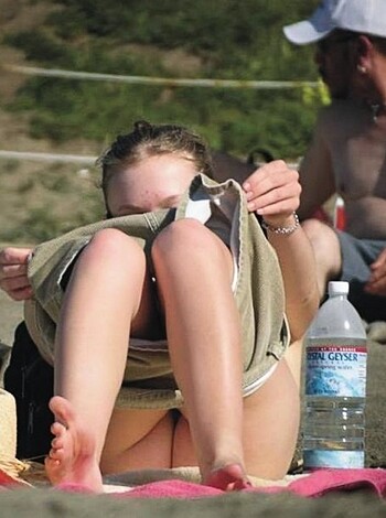 A fucking brat covering up her ugly mug at the shore, goddammit!