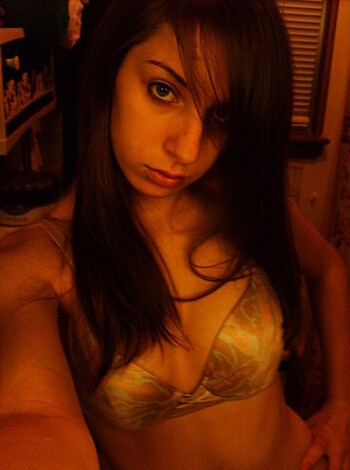 This image depicts a scantily clad broad in a two-piece bathing suit, showing off her ample assets.