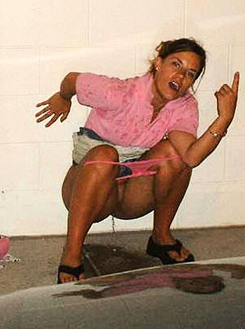 This is a fucking picture of some bitch bent over, dropping a load, her ass hanging out of her panties as she takes a dump on the ground next to a goddamn car.