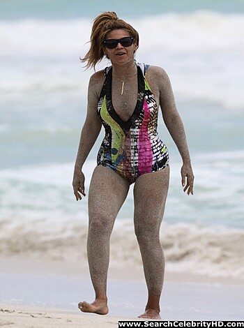 A bare-assed bitch strollin' along the shore, sand clingin' to her skin like a motherfuckin' disease.