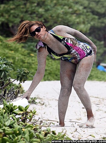 The image is of a bikini-clad broad who's been fucking on the beach, now she's strutting her stuff to go piss in the goddamn sea, you perverts.