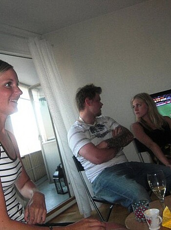 Vulgar description: A bunch of dudes chillin' at a bar, fuckin' drinking beers while they watch the game on the big screen.