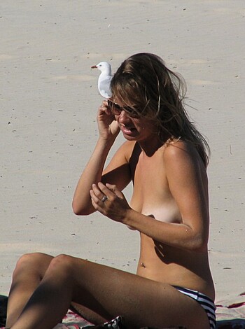 "Here's a busty blonde babe, sunbathing topless at the beach, with a chubby seagull perched upon her milky-white mammary glands."