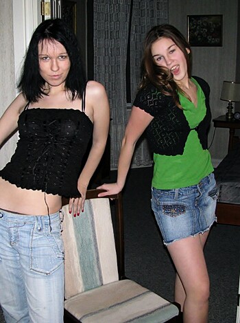 A photo of two chicks; one with tits out, the other in a green tank.