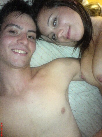 Naked man and woman on their backs with boners, grinning at the camera.