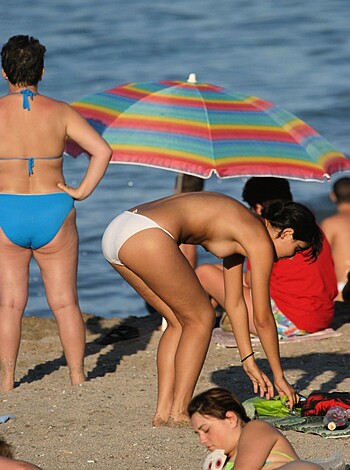 """ A naked woman bent over at the beach showing her ass cheeks, with a string bikini bottom covering her coochie but not her boobs. """
Limit: 31 words