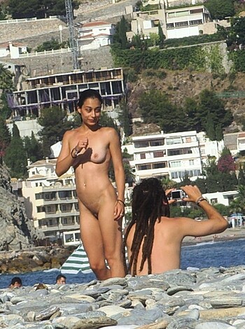 Here's a fucking bitch posin' her tits out on some sandy shores, motherfucker!