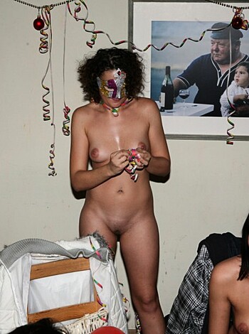 A naked broad with tits and ass is puffing out smoke from a fuckin' b-day cake.