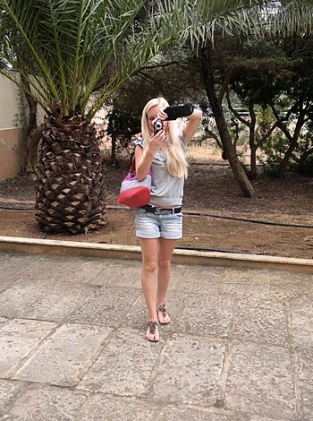 A woman taking a fucking hot shot of her tight ass cheeks.