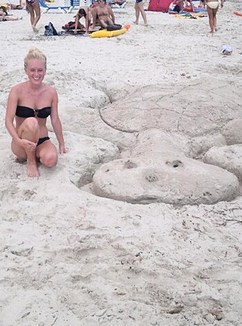 "Dude! Check out this hot babe with her tits hanging out of her bikini on some fucking sand castles!"